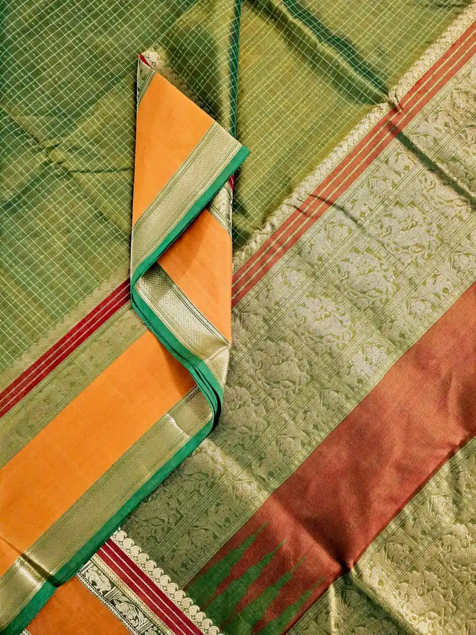 A close up of Lakshadeepam Handloom Kanchi Silk Cotton Saree | Forest Green with Mustard-Rust Pallu & Temple Zari Border