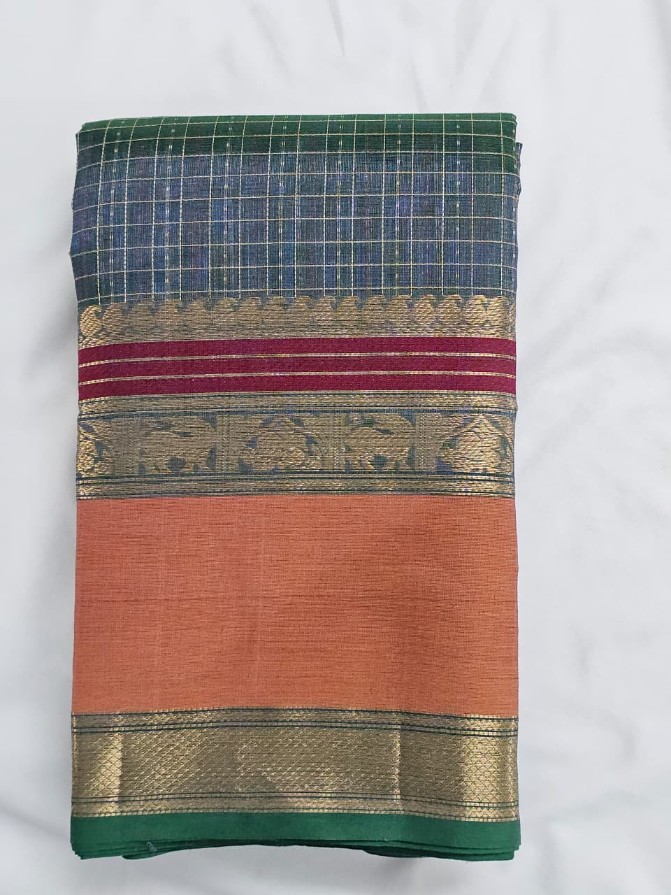 A folded Lakshadeepam Handloom Kanchi Silk Cotton Saree | Muted Steel Blue with Mustard Yellow Zari Border